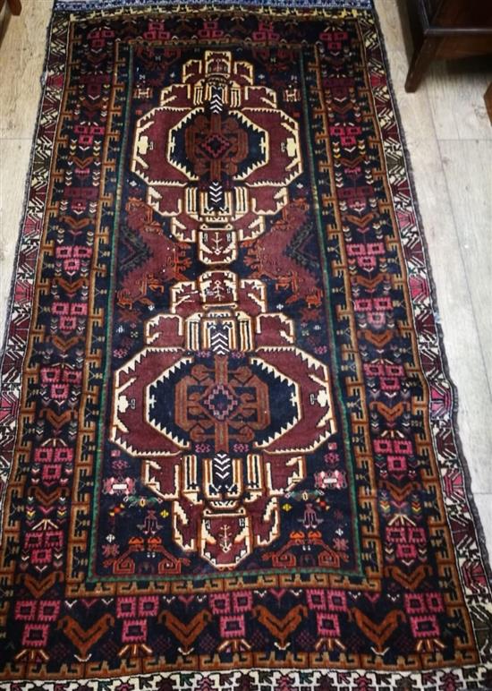 A Caucasian dark red ground rug 205 x 115cm